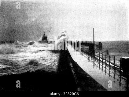 Tynemouth Jetty during the recent storm, 1898. 'the middle of last week brought a gale which raged with increasing volume throughout Thursday, Friday, and Saturday, carrying havoc of all kinds in its train. Snow fell heavily in various parts of the country, and railway traffic was seriously impeded...It was at sea and on the coast, however, that the stormy weather wrought its worst effects. At Hartlepool a Norwegian schooner went ashore, and her crew were only rescued by the life-boat with great peril. Several arduous rescues were made off the Yarmouth coast, not, unhappily, without loss of li Stock Photo