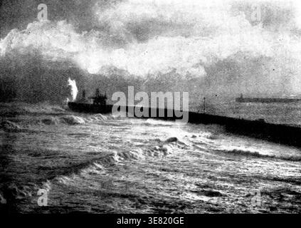 Tynemouth Jetty during the recent storm, 1898. 'the middle of last week brought a gale which raged with increasing volume throughout Thursday, Friday, and Saturday, carrying havoc of all kinds in its train. Snow fell heavily in various parts of the country, and railway traffic was seriously impeded...It was at sea and on the coast, however, that the stormy weather wrought its worst effects. At Hartlepool a Norwegian schooner went ashore, and her crew were only rescued by the life-boat with great peril. Several arduous rescues were made off the Yarmouth coast, not, unhappily, without loss of li Stock Photo