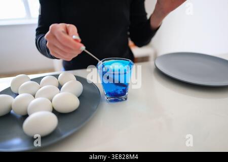 Preparing Easter eggs at home, natural ritual of decorating with colored dye. Stock Photo