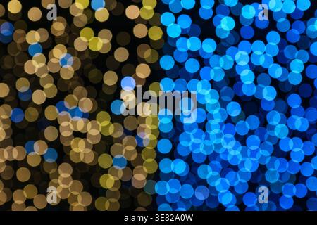 Abstract bokeh lights background in blue and gold. Vibrant blurred circles for festive, luxury, and technology decorative design concepts. Stock Photo