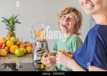 Mother and son cooking together in kitchen at home. Happy family preparing meal and spending time together. Parenting, bonding, healthy lifestyle Stock Photo
