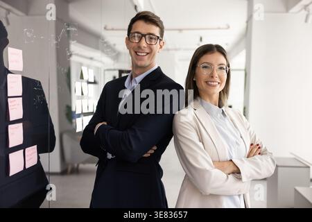 Two confident business partners standing together at workplace Stock Photo
