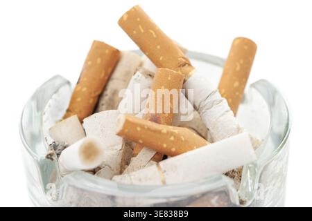 Bunch used cigarettes inside ashtray isolated white background macro Stock Photo