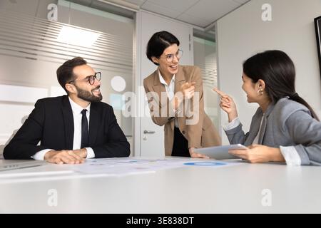 Multiethnic team smiling, finding solution, enjoy friendly teamwork in office Stock Photo