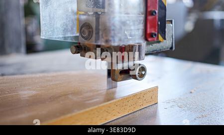 Bandsaw blade cutting wood in a woodworking workshop Stock Photo