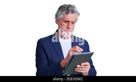 Mature businessman working on digital tablet with stylus Stock Photo