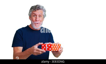Mature man holding surprise gift box celebrating something Stock Photo