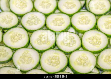 Cucumber pattern backdrop. Background design showcasing detailed cucumber skin textures with delicate seed arrangements and smooth color transitions Stock Photo