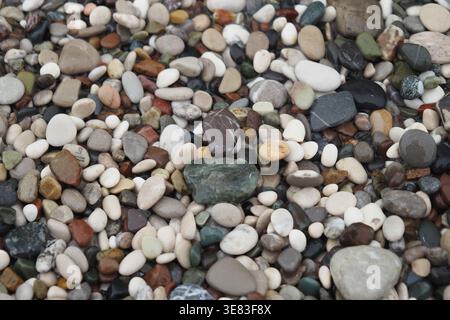 Colorful stones scatter on the ground at a beach Stock Photo