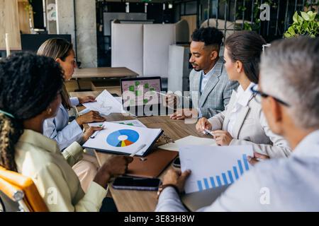 Modern Workspace Where Diverse Opinions Are Valued During Data Analysis And Decision Making Stock Photo