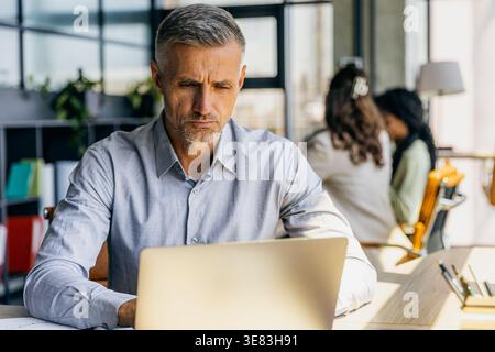 Person assesses project timeline alongside team members Stock Photo