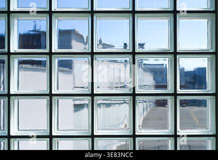 Clean glass bricks or glass blocks wall with sunlight as background Stock Photo