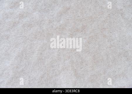 Close-up of soft white mohair fabric with delicate fibers and fluffy texture. Stock Photo