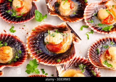 Cooked scallops with parsley on a baking sheet Stock Photo