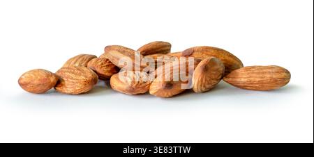 Almond nuts in stacks are isolated on white background with clipping path. Stock Photo
