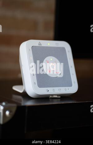Smart security hub sitting on a wooden surface Stock Photo
