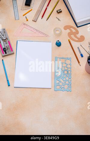 Blank spiral notebook with geometry drafting tools background. Various drawing instruments for school or engineering. Desk top view copy space Stock Photo