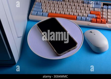 Modern workspace featuring cellphone Stock Photo