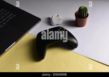 Black videogame controller on desk surface Stock Photo