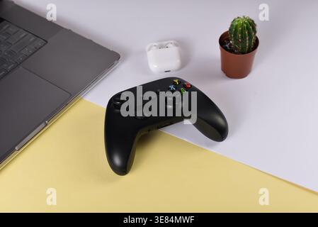 Black videogame controller on desk surface Stock Photo