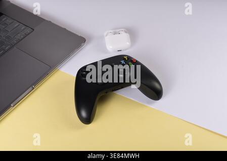 Black videogame controller on desk surface Stock Photo