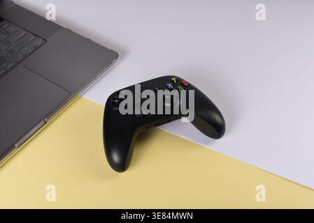 Black videogame controller on desk surface Stock Photo