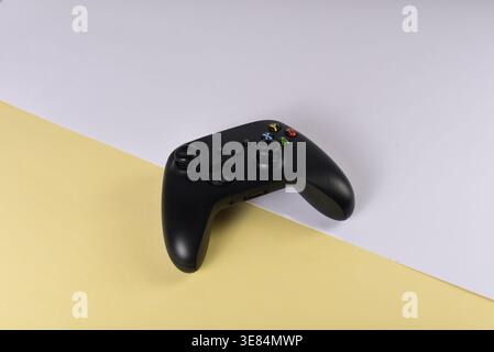 Black videogame controller on desk surface Stock Photo
