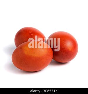 Group of three brown chicken eggs lying on a white surface. Stock Photo