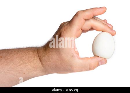 Close up of two fingers holding a white peeled boiled egg Stock Photo
