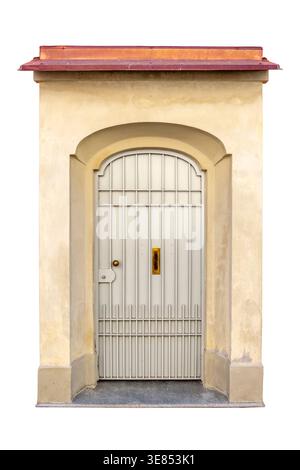 Classic-style arched entrance with metal gate with vertical slats, framed by masonry niche, and protected at the top by small canopy with copper flash Stock Photo