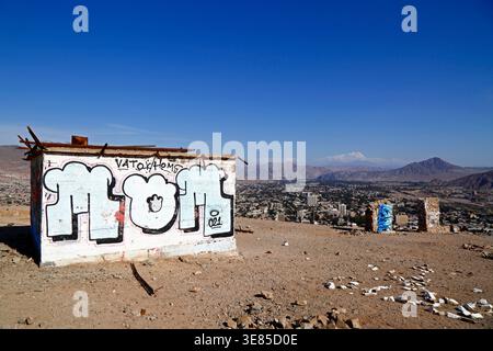 View over city centre and graffiti on old brick structure on summit of Cerro de la Cruz, Copiapó, Región de Atacama, Chile Stock Photo