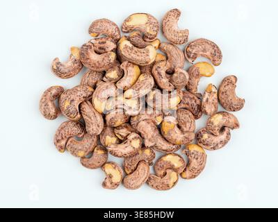 Cashew nuts in shell on light background, top view Stock Photo