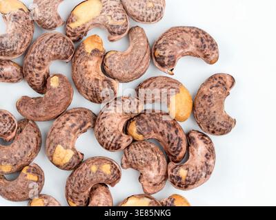 Cashew nuts in shell on light background, top view Stock Photo