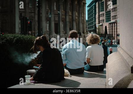 London street scene with City workers on lunch break, City of London, UK Stock Photo
