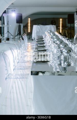 Luxury banquet table setting with glassware and modern decor prepared for event. Stock Photo