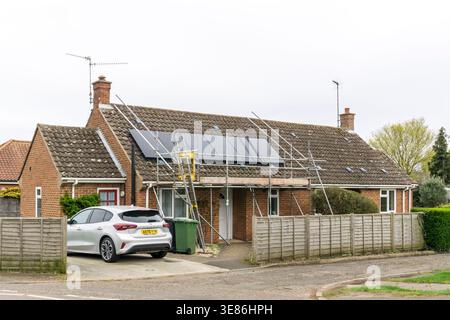 New solar panels being installed on a Norfolk bungalow. Stock Photo