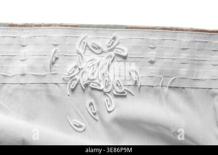 Plastic curtain hooks ont a curtain pleat preparing to hang curtains background backdrop. Stock Photo