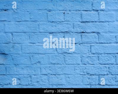 Front View of a Light Blue Brick Wall with Rough Plaster Texture Background. Copy space. Stock Photo