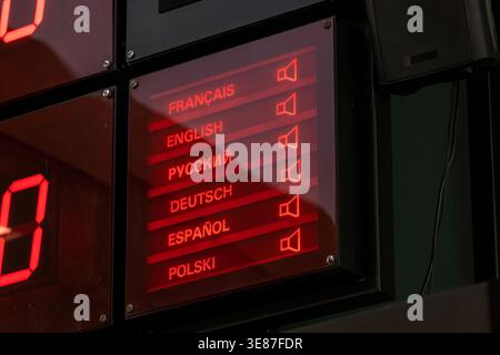 Multilingual audio guide language selection display with European languages and speaker icons, red illuminated panel for translation, accessibility an Stock Photo