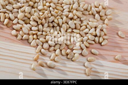 Pine nuts on a wooden surface. Natural background Stock Photo