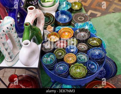 High-angle view of a multi-coloured collection of hand-painted Moroccan ceramics displayed at a Marrakech Medina souk Stock Photo