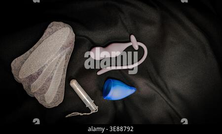 Womens Intimate Care Products and Pelvic Floor Trainer on Black Background Stock Photo