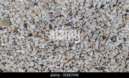 Top view of small light gray and beige pebbles background Stock Photo