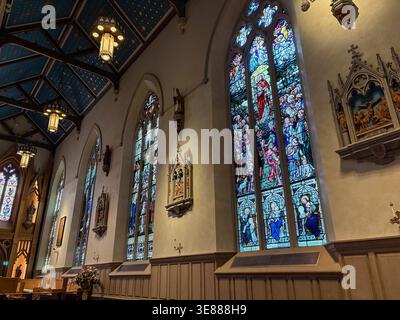 Stained glass windows and Gothic Revival architecture inside St. Michael's Cathedral Basilica, a historic landmark in Toronto, Canada. Stock Photo