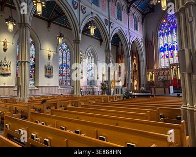 The interior of St. Michael's Cathedral Basilica in Toronto, Ontario, Canada, featuring Gothic Revival architecture and stained glass windows. Stock Photo