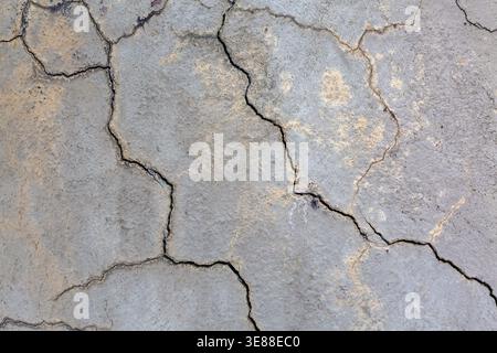 Close-up of multiple small cracks and deep fissures on grey painted concrete foundation exterior house wall in poor condition, Quebec, Canada Stock Photo