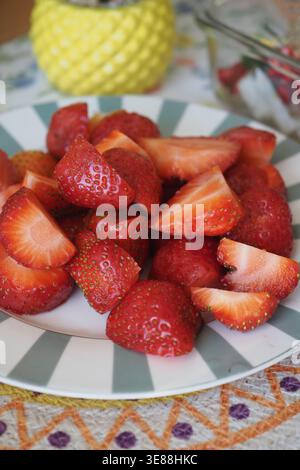 Fresh strawberries arranged on a plate in the kitchen Stock Photo