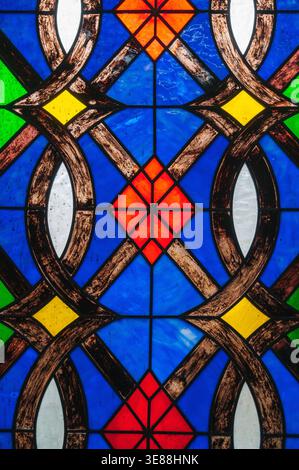 A detail of a multi-colored panel from a stained glass window in a Catholic church Stock Photo