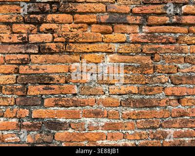 A detailed closeup of aged terracotta bricks showcasing weathered historical textures perfect for architectural backgrounds and construction projects. Stock Photo