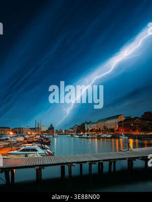 HELSINKI, FINLAND. spectacular, powerful lightning bolt strikes from a dark stormy sky over the harbor and waterfront architecture in Helsinki Stock Photo